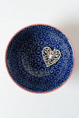 wooden ornament isolated inside a blue bowl