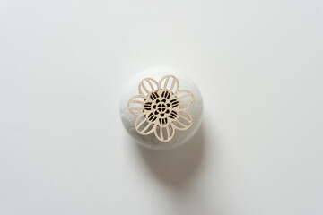 wooden spiral flower on a ceramic object isolated on blank paper