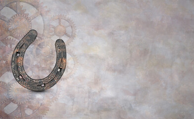 High angle view of a horseshoe and gears on grunge background. Historical abstract concept for text.