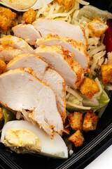 
lettuce in a black container on a white background