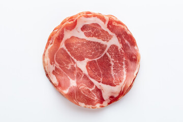 Italian prosciutto crudo or jamon. Raw ham. Isolated on white background.