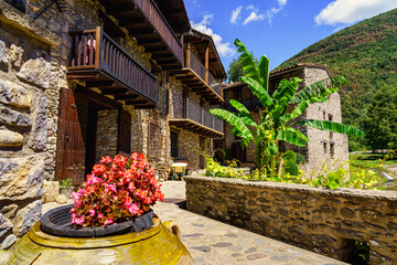 Typical houses made of stone and wooden balconies in the mountain village of Beget, Girona, Spain.