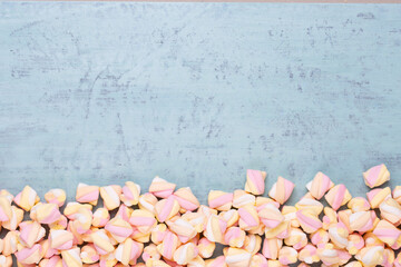 Marshmallows on blue background with copyspace. Flat lay or top view. Background or texture of...