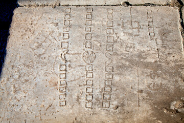 An ancient Roman game-stone carved in the floor. Didyma, Aydin, Turkey