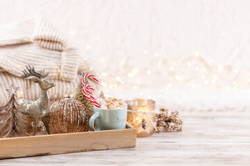 Fototapeta na wymiar Cup with a hot drink, marshmallow on a table with christmas decorations.