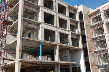 Concrete on construction buildings with scaffold and tower crane