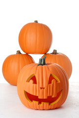 closeup happy jack o lantern pumpkin with pile on a white background