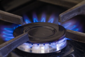 A natural gas burner with large flames. Concept for saving gas and energy during the gas crisis.