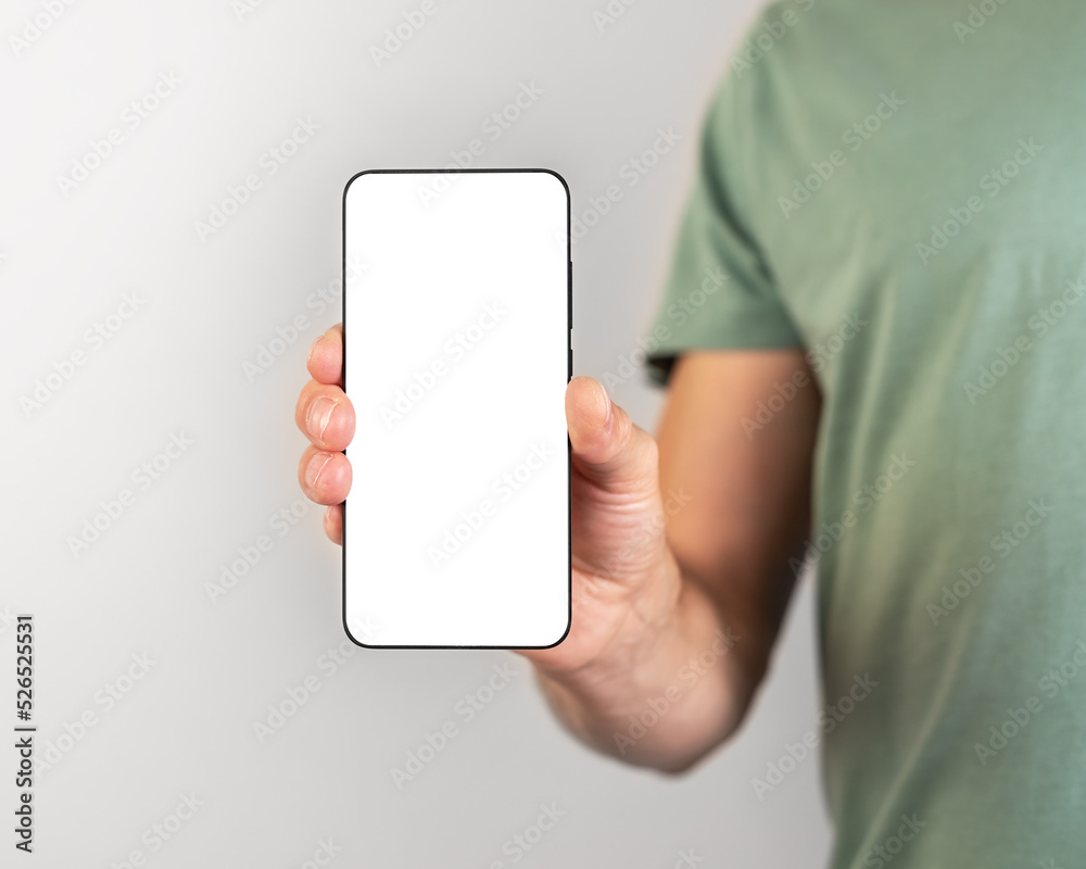 Poster Man holding phone mockup in vertical position. Person using smartphone for showing photo or information. empty screen