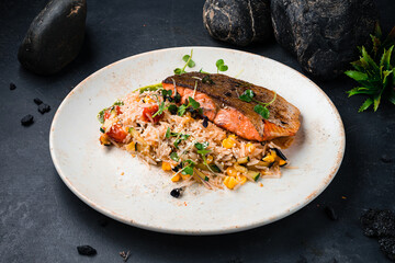 Fried salmon steak. Asian dish. Fried salmon with rice and vegetables