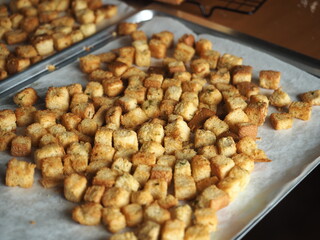 Golden crispy garlic butter croutons in baking tray