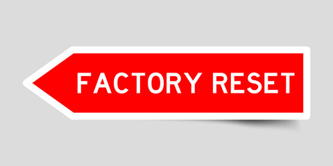 Red color arrow shape sticker label with word factory reset on gray background