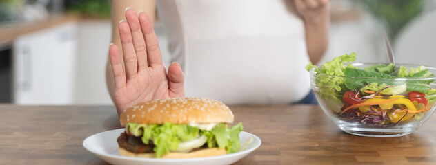 Women avoid fast food during diet sessions to lose weight and choose healthy food that has vitamins...