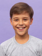 Cute young boy in white T-shirt posing in front over lilac background. Portrait of fashionable male child. Smiling boy posing, blank wall on background. Concept of children style and fashion.