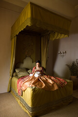 Renaissance woman under canopy of her bed © Anneke
