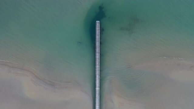 Bird Eye POV on a pier with calm blue water