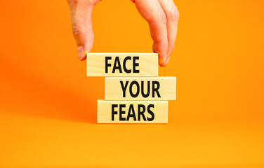 Face your fears and support symbol. Concept words Face your fears on wooden blocks. Businessman...