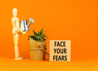 Face your fears and support symbol. Concept words Face your fears on wooden blocks. Businessman...