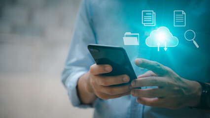 A man uses a smartphone to access an online document database. and automated processes to store files and documents in the organization effectively with enterprise business ERP technology