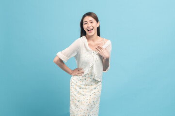 Beautiful young asian woman in white dress with flower pattern  isolated on blue background