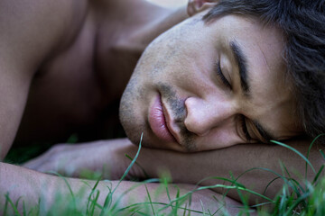 Young man asleep in the grass