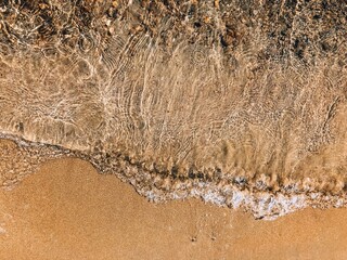Clear water on the sand. golden beach top view