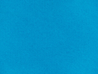 Background with a plain blue paper texture. Textured background made of light blue kraft paper. blue retro paper background. Vintage cardboard texture. Grunge-style drawing paper