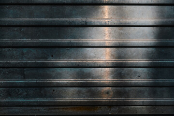 An old dirty and rusty sheet of corrugated iron Industrial background The texture of a crumpled aluminum fence