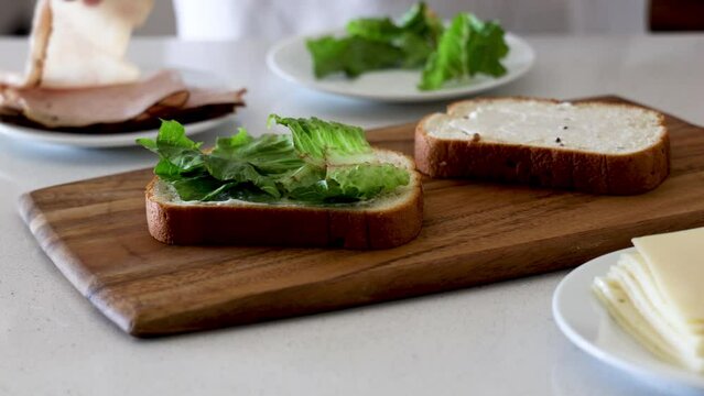 Adding Turkey to Bread to Make a Sandwich