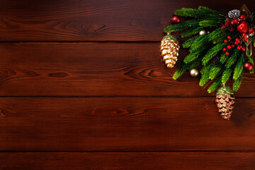 Horizontal Christmas or New Year wooden background with decorations in the top corner, space for text, top view.