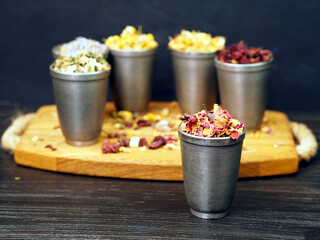 Antique metal cups with medicinal herbs