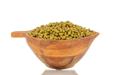 Lots of organic uncooked mung beans in a wooden cup, close-up, isolated on a white background.