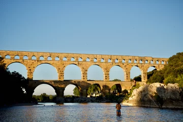 Papier Peint photo Pont du Gard The Magnificent roman "Pont du Gard" bridge and aqueduct at sunset in summer in the south of France. 