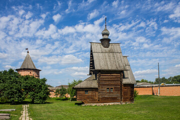 The courtyard of the Kremlin in Yuriev-Polsky in Russia with ancient architecture on bright green grass on a sunny summer day and a space for copying