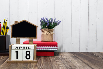 April 18 calendar date text on white wooden block on wooden desk.