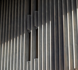 Gray and White Building Facade with Sunlight and Shadows.