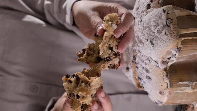 Easter dove in female hands . Colomba di Pasqua - traditional italian easter dove cake with glaze macaranage, almonds. Easter dove on a board. High quality 4k footage