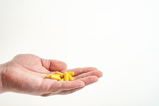 a handful of medicine in a man's hand