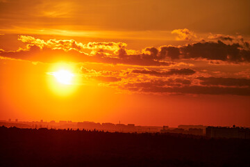 Evening sky with setting sun through clouds at sunset, cloudy landscape