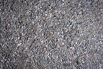 Grey small road stone background. Gray rocks ground texture. 