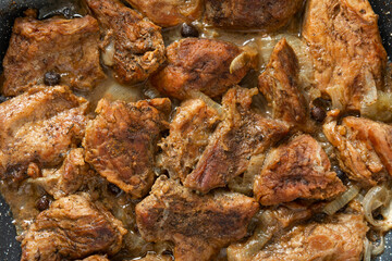 Juicy pieces of beef steak in a frying pan with spices and salt. Delicious food concept. Recipe for cooking juicy meat.
