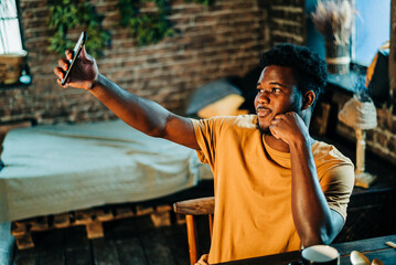 Handsome attarctive man making selfie, admiring himself in cellphone, happy male man communication...