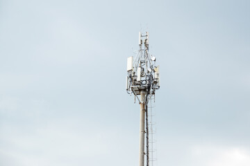Communication tower design or Construction of communication mast on cloudy sky. Wi-Fi wireless network, mobile communication, radio relay communication system, navigation, television