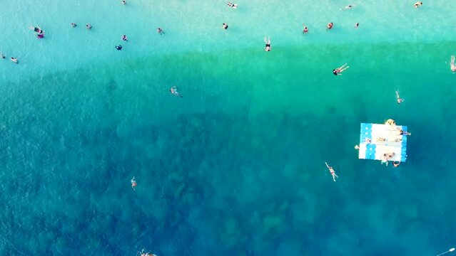 Drone video of swimmers in the sea. Antalya Kas public beach stock video