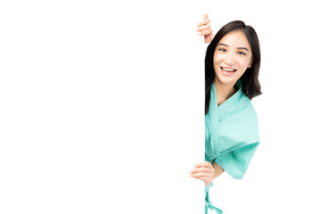 Excite asian woman hiding behind white wall with blank space isolated on white background Patient...