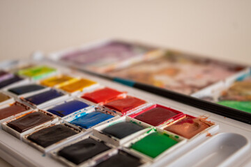 A colorful watercolor palette used for painting