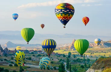 Poster The great tourist attraction of Cappadocia - balloon flight. Cappadocia is known around the world as one of the best places to fly with hot air balloons. Goreme, Cappadocia, Turkey © olenatur
