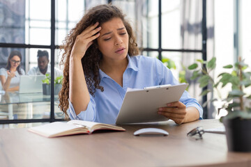 Worried frustrated businesswoman shocked by bad news, stressed businesswoman troubled with financial problem. Collegues are on the background.