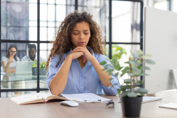 Worried frustrated businesswoman shocked by bad news, stressed businesswoman troubled with financial problem. Collegues are on the background.