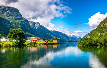 Naklejka na ściany i meble Amazing nature view with fjord and mountains. Beautiful reflection. Location: Scandinavian Mountains, Norway. Artistic picture. Beauty world. The feeling of complete freedom